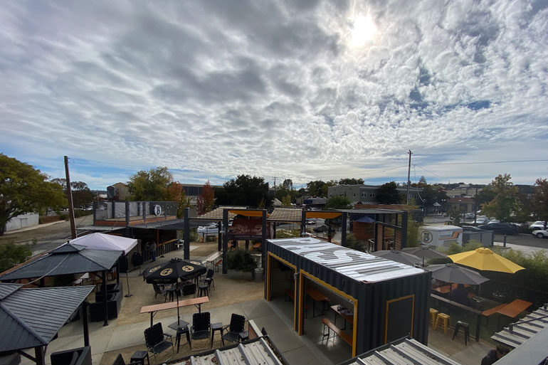 birds-eye view of The Backyard beer garden with cloudy sky