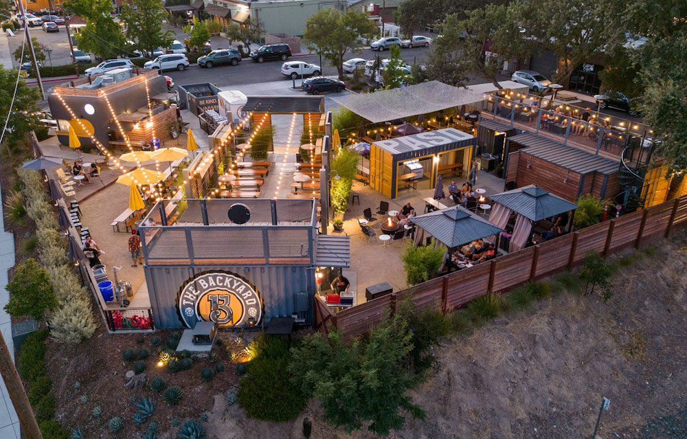 aerial view the the backyard beer garden in downtown paso robles with lights firepits and patios