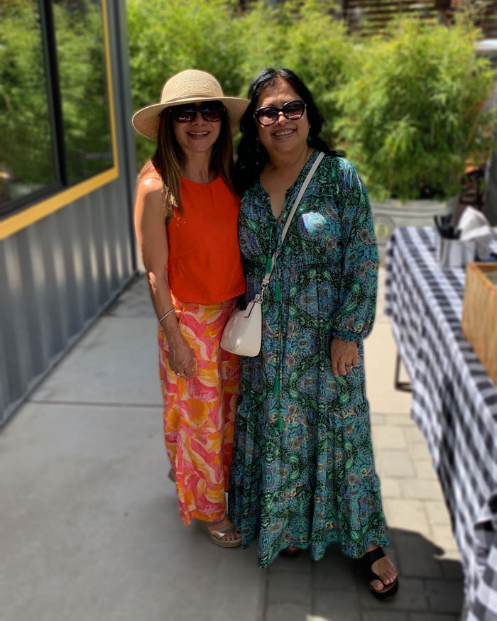 mother-of-the-bride-send-off-brunch two ladies standing in an outdoor beer garden smiling